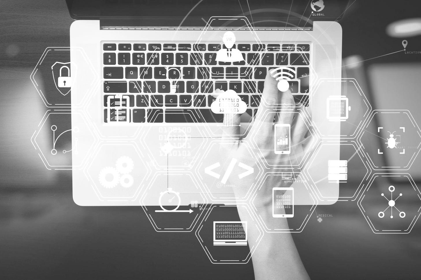 Security professional analyzing network vulnerability assessment results on multiple computer screens